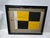 International maritime signal flag of letter "L", "LIMA", set into a shadowbox frame. The cotton flag has a white canvas...