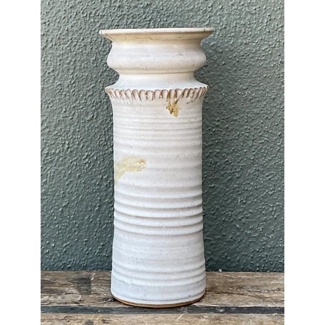 Crafted with rustic studio art pottery techniques, this vintage cylindrical stoneware vase features a hand-thrown ribbed...