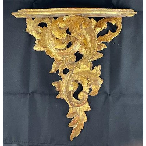 Add a touch of elegance to your home with this mid-century gilded, carved wood wall bracket. Perfect for displaying a...