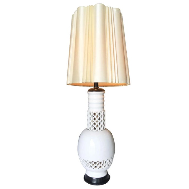 Large Mid Century white ceramic "Infinity" table lamp featuring repeating infinity pattern with a ripped neck. The lamp is...