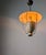 Perforated metal pendant lamp manufactured in Italy during the 1940s. Structural composition features a wide, circular top...