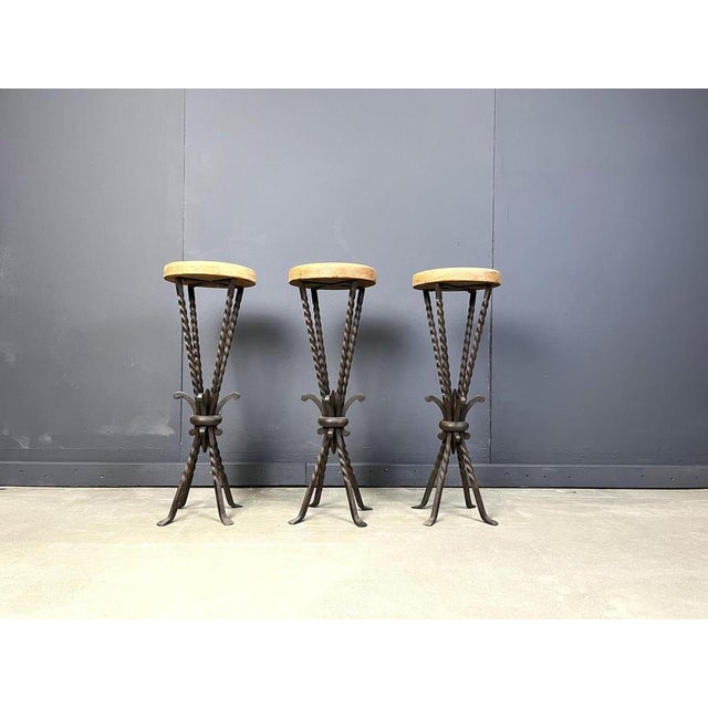 Vintage bar stools made from a round oak seat and a beautiful wrought iron twisted base with elegant feet. 1960s - France...