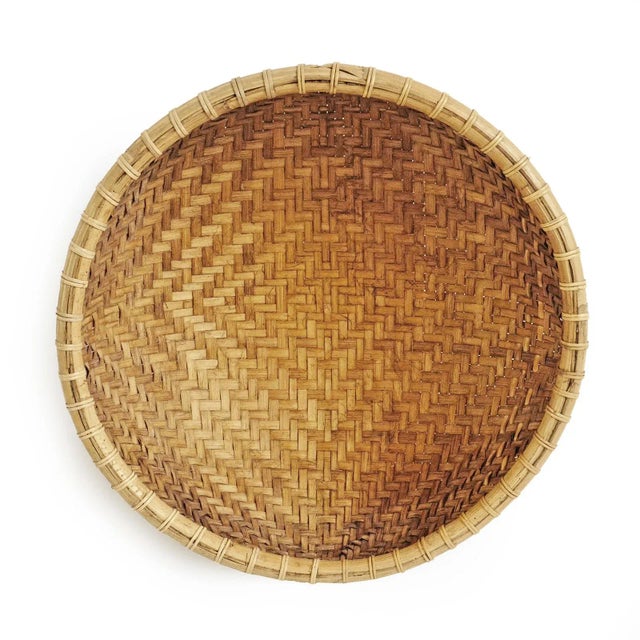 Vintage Javanese bamboo hand woven round basket with attractive two-tone natural fibers. Many uses from storage to...