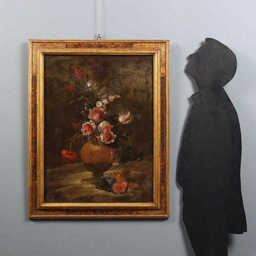 Oil on canvas. Central Italian School, 18th century. A composition of variegated flowers is placed inside an amphora vase,...