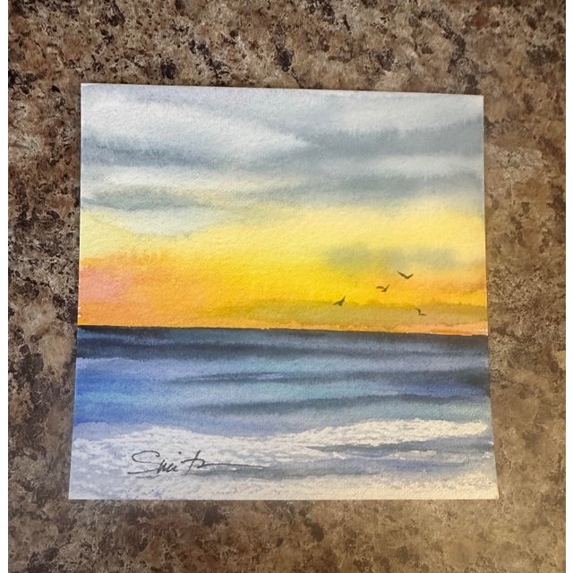 A vibrant sunrise spills golden and peach tones across the sky while waves roll toward the shore. A soothing yet uplifting...