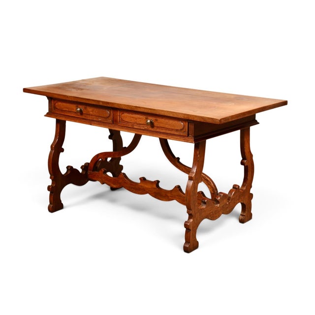 This is a wonderful side or writing table in solid walnut that perfectly adheres to the Baroque aesthetic. The carved...