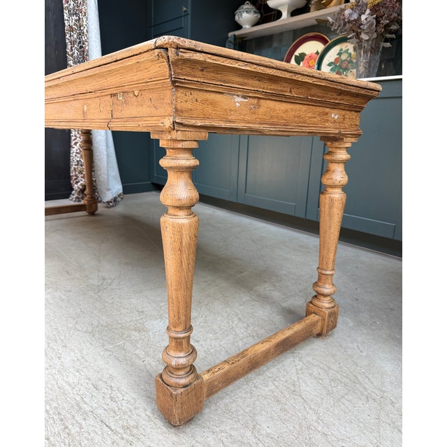 Large oak farmhouse table dating from the late 19th century. With its elegant turned legs, molded apron, and long top...