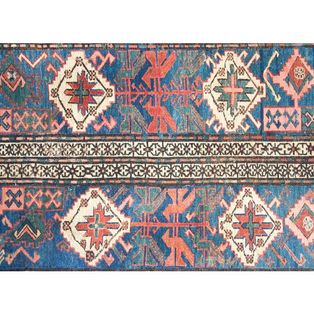 A stunning early 20th century Persian Soumak runner with the most wonderful tribal pattern with several white diamond...