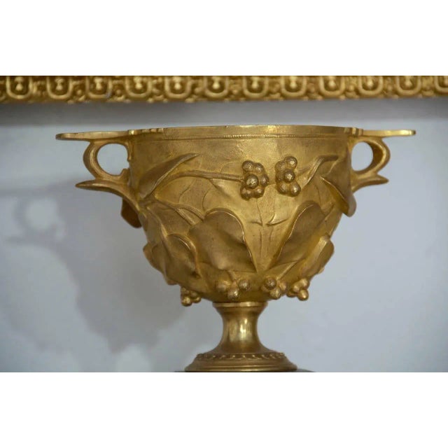 Circa 1830 magnificent rare pair of gilt bronze exuberant Classical Roman style decorated urns with highly raised finely...
