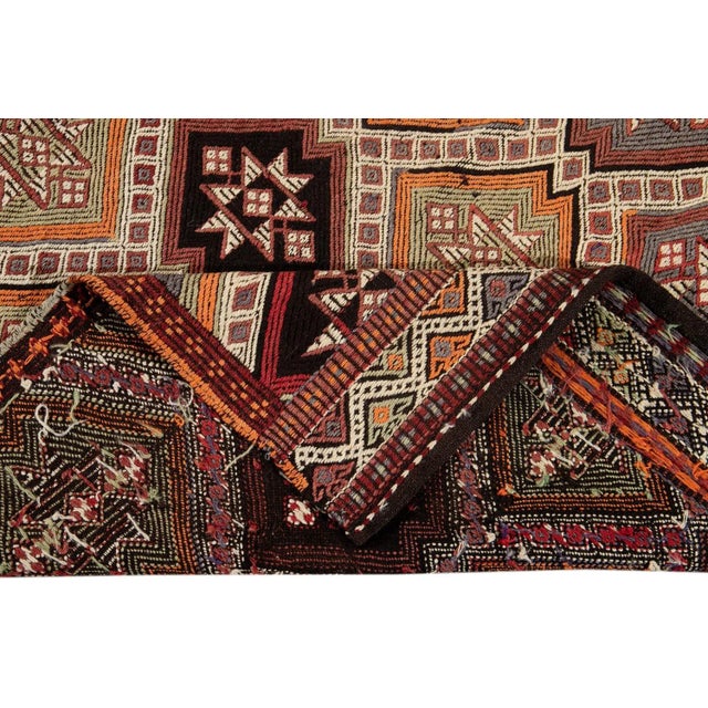 Beautiful vintage Turkish Sumakh hand-knotted wool runner with a beige field. This piece has multi-color accents in an...