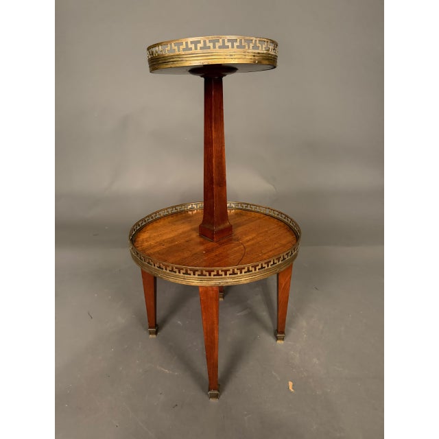 Elegant 19th-century French Neoclassical style tiered side table dating to circa 1890. Crafted in what appears to be...