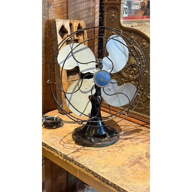 Classic vintage Emerson Electric table fan model 2450B featuring a striking four-blade design with original cage and black...