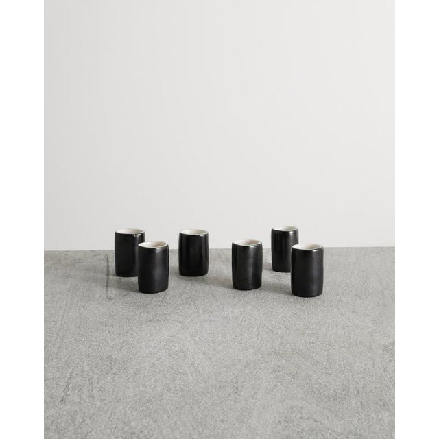 A rare set of six decorative french mid century black, white and light blue enameled espresso cups by denise gatard...