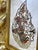 This leather panel is pierced into filigree by hand and painted cell by cell in aubergine, terracotta, moss and ivory,...