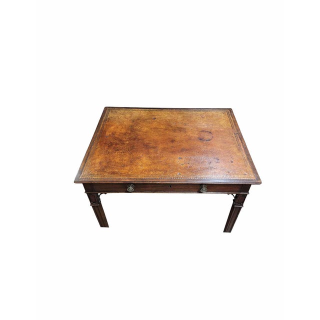 A Georgian Mahogany ladies writing table with original leather, handles and castors, with square tapering paneled legs,...