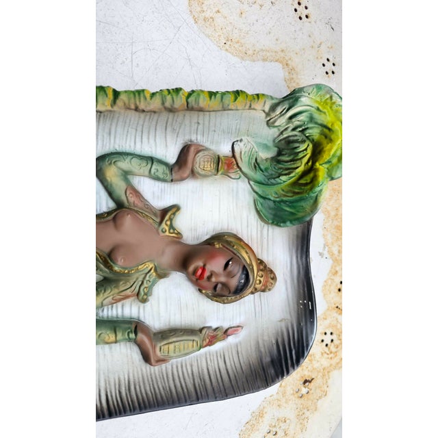 Plaster decoration of an African woman, signed G. Monot 1962, dimensions: height 38.5 cm, width 24.5 cm, depth 5.5 cm.