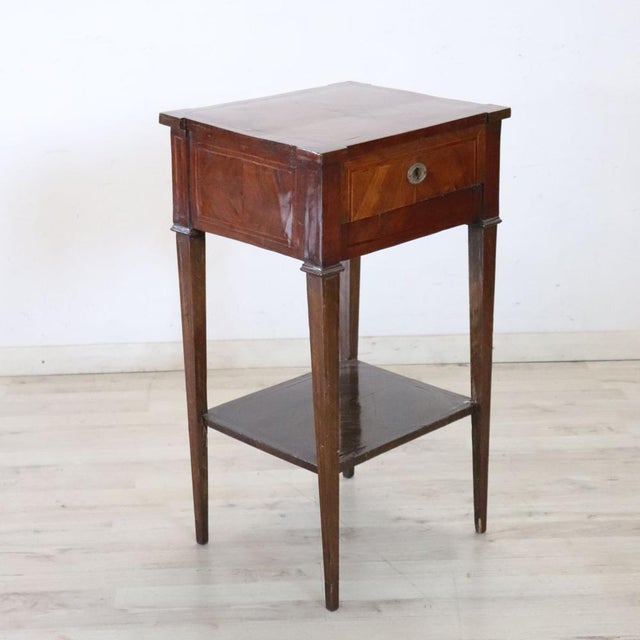 We present this refined antique Italian bedside table dating back to the second half of the 18th century. It features...