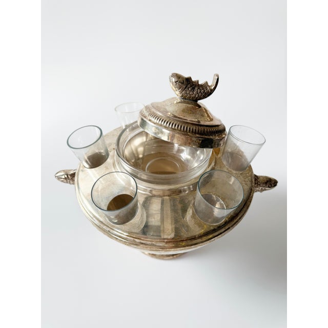 Silver plated sardine and vodka serving dish, measures 10" across and 9" tall. Includes six cone shaped glasses and dish...