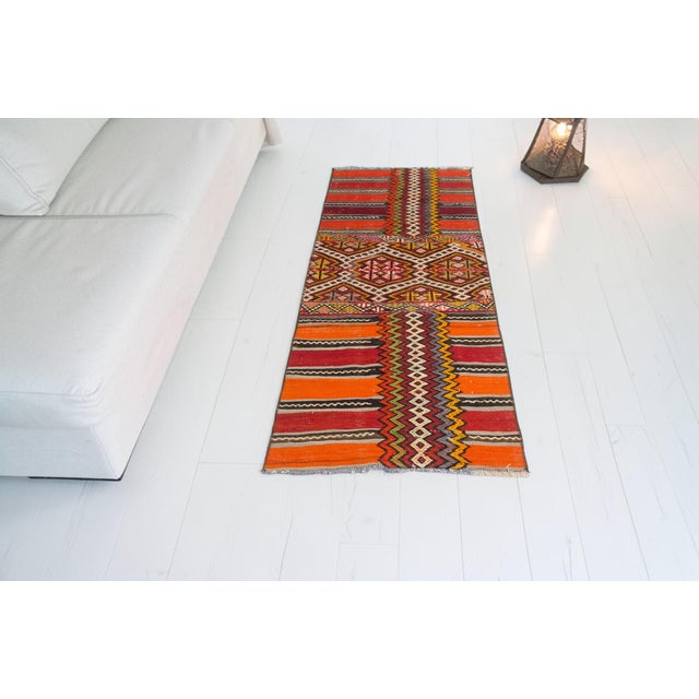This is a vintage Turkish Oushak rug from the Mid 20th Century. The piece was hand-knotted.