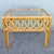 Charming vintage Boho Chic side table crafted from natural rattan with a warm honey-toned finish. The open frame features...