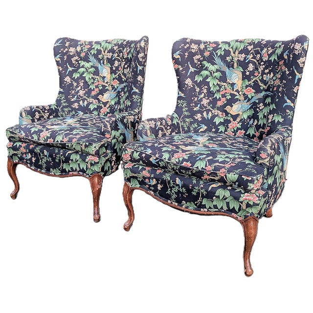 A striking pair of vintage Queen Anne-style wingback lounge chairs upholstered in what appears to be Sanderson's...