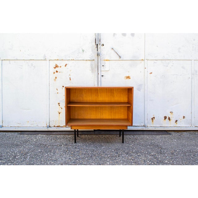 Sideboard with wooden frame and iron legs. Designer Leonardo Fiori Manufacturer ISA Bergamo 1950s This piece has an...