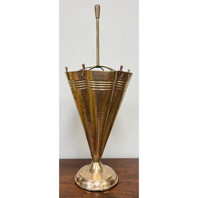 Vintage detailed brass umbrella stand with umbrella motif. Whimsy meets function with this practical piece. Polished with...