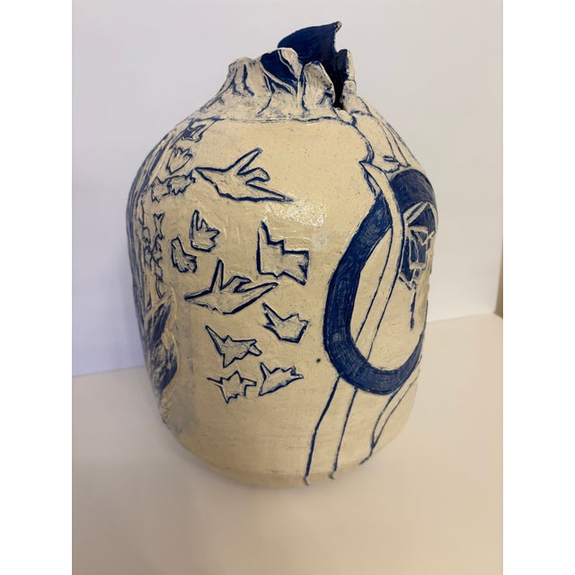 This vintage abstract style vase designed with blue and white features depicting birds and feathers is truly unique. Age...