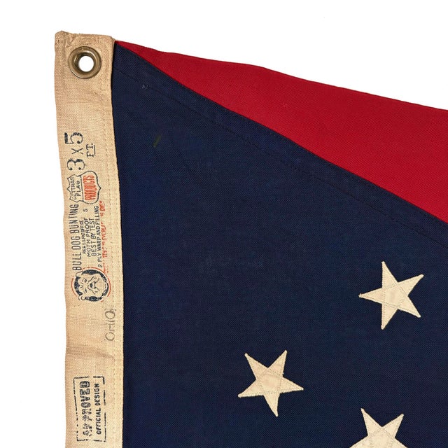 This vintage Ohio flag is made from a cotton cloth, with fully sewn design visible on both sides. Please note overall...