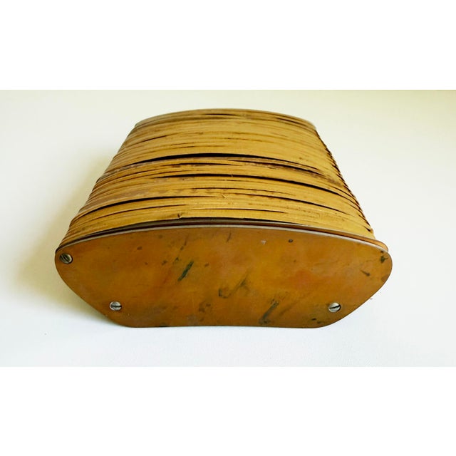 An oak cigarette box with bronze sides and a cane-wrapped lid. The piece is in need of restoration. See condition notes....
