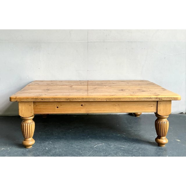 Embrace the warm, inviting essence of farmhouse charm with this vintage knotty pine coffee table, beautifully blending...