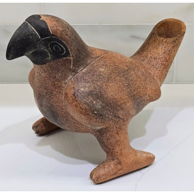 A striking hand-formed terracotta bird effigy vessel in the tradition of Mexican folk art pottery, marked "Mexico" with...
