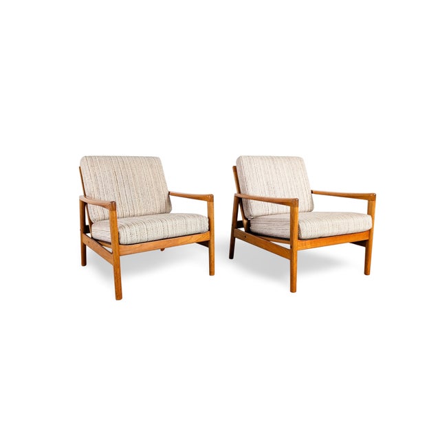 Beautiful vintage armchair from the 1960s for sale. The armchairs feature refinished wooden frames made of high-quality,...