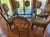 A custom round dining set featuring a thick glass tabletop, substantial base, and eight matching chairs. The six-foot...
