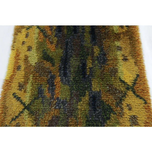 Hand-knotted in lush, high-pile wool in Sweden circa 1960-1970, this 3x5 vintage Swedish Rya rug is a bold new addition to...