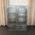This industrial, double-wide, brushed steel, medical apothecary display cabinet is circa the early 1940s. The cabinet...