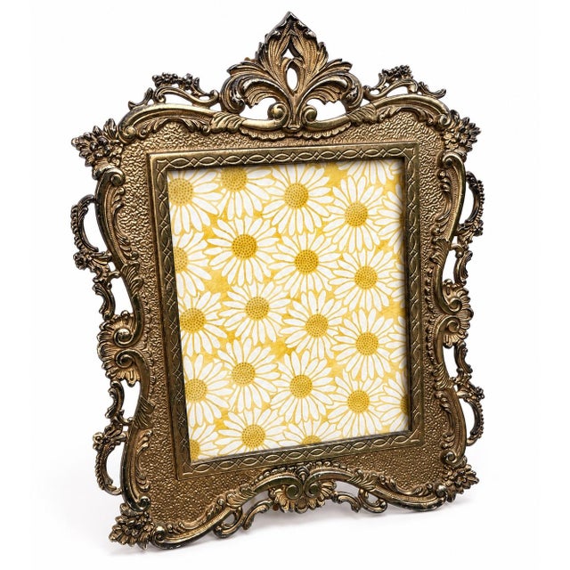 A striking antique Rococo Revival picture frame dating to the early twentieth century, beautifully crafted in heavy cast...