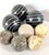 A curated set of 8 decorative stone spheres in mixed materials including marble, granite, and carved soapstone, ideal for...