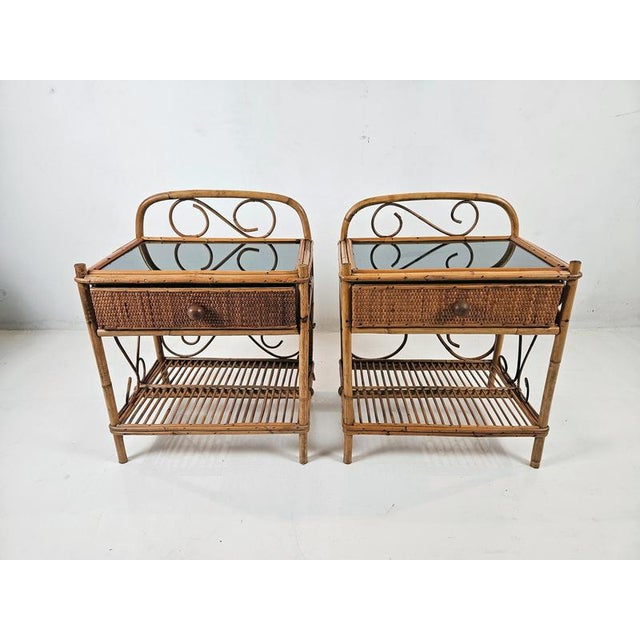 A pair of handmade elegant and sleek nightstands in bamboo. Each stand has one drawer at the top and a shelf at the bottom.