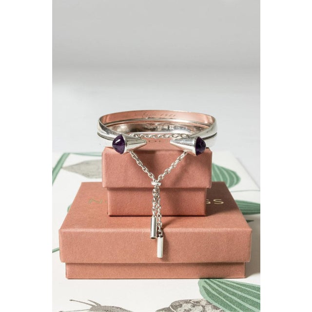 Exquisite silver bracelet by Einari Ailio, with two amethyst stones in an imaginative design. The bracelet is held...