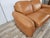 1970s orange leather sofa, Piumotto model, designed by Arrigo Arrigoni for Busnelli. The sofa features a two-seater seat,...