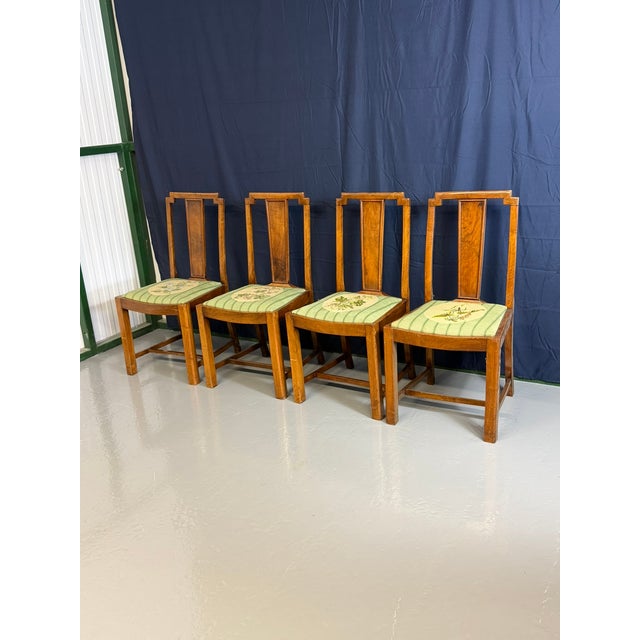 Set of four antique Maplewood dining chairs, stylized in the Arts and Crafts or early Art Deco aesthetic. Constructed from...