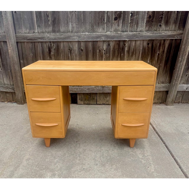 Heywood Wakefield model C3777 kneehold desk by Leo Jiranek in Champagne finish c. 1941-42. One long center drawer and two...