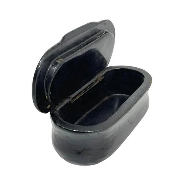 18th century papier-mâché small snuff box A black lacquered papier-mâché snuff box with a silver inlaid encircled zig zag...