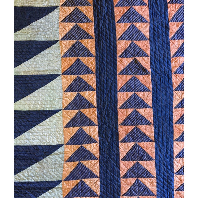 A fine American quilt of satin patchwork executed in the Flying Geese pattern circa late 19th to early 20th century. The...