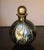 This kaleidoscopic bottle was created to hold a fine perfume. In the typical style of IOW (Isle of White) Glass bottles,...