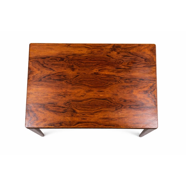 An elegantly proportioned, straight-lined coffee table in the Mid-Century Modern style, featuring a distinctive, richly...