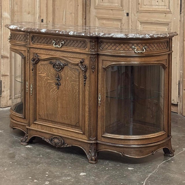 A refined late 19th century Liégeois display buffet, beautifully executed in richly grained oak and crowned with its...