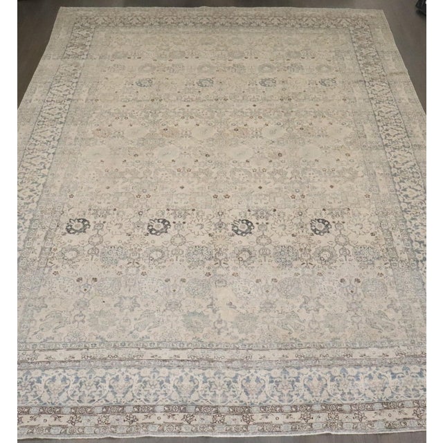 an early 20th Century Persian Tabriz Carpet with an all over design in neutral tones