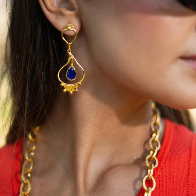 Step into the elegance of ancient Egypt with the Cleopatra’s Sapphire Tears Gold Earrings. Handcrafted from bronze and...